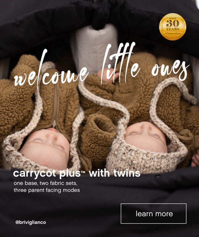 Two babies resting in their twin carrycot plus™ while travelling in a Mountain Buggy double stroller