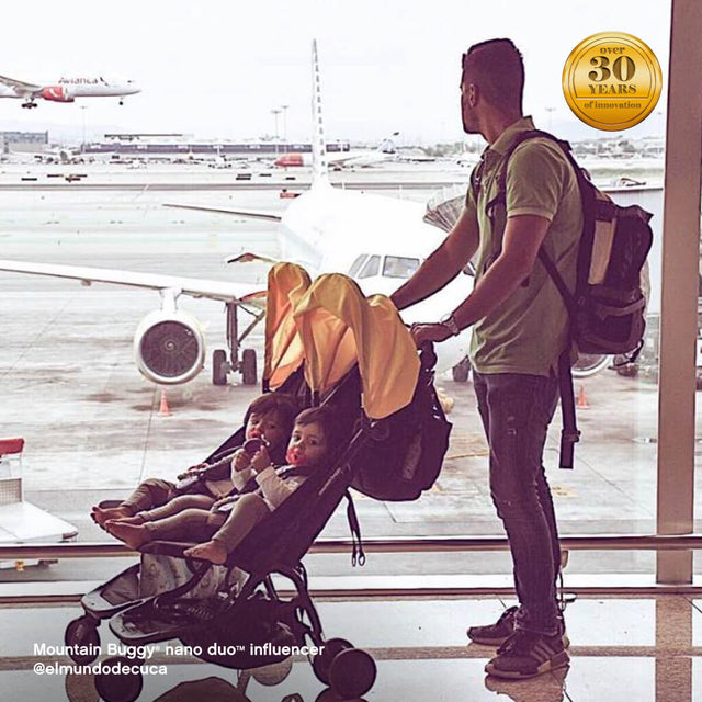 dad with two toddlers in nano duo buggy, waiting at the airport - Mountain Buggy nano duo™ influencer @elmundodecuca